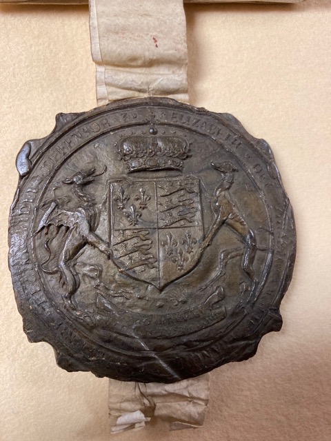 A close up of a large old wax seal from the 13th century